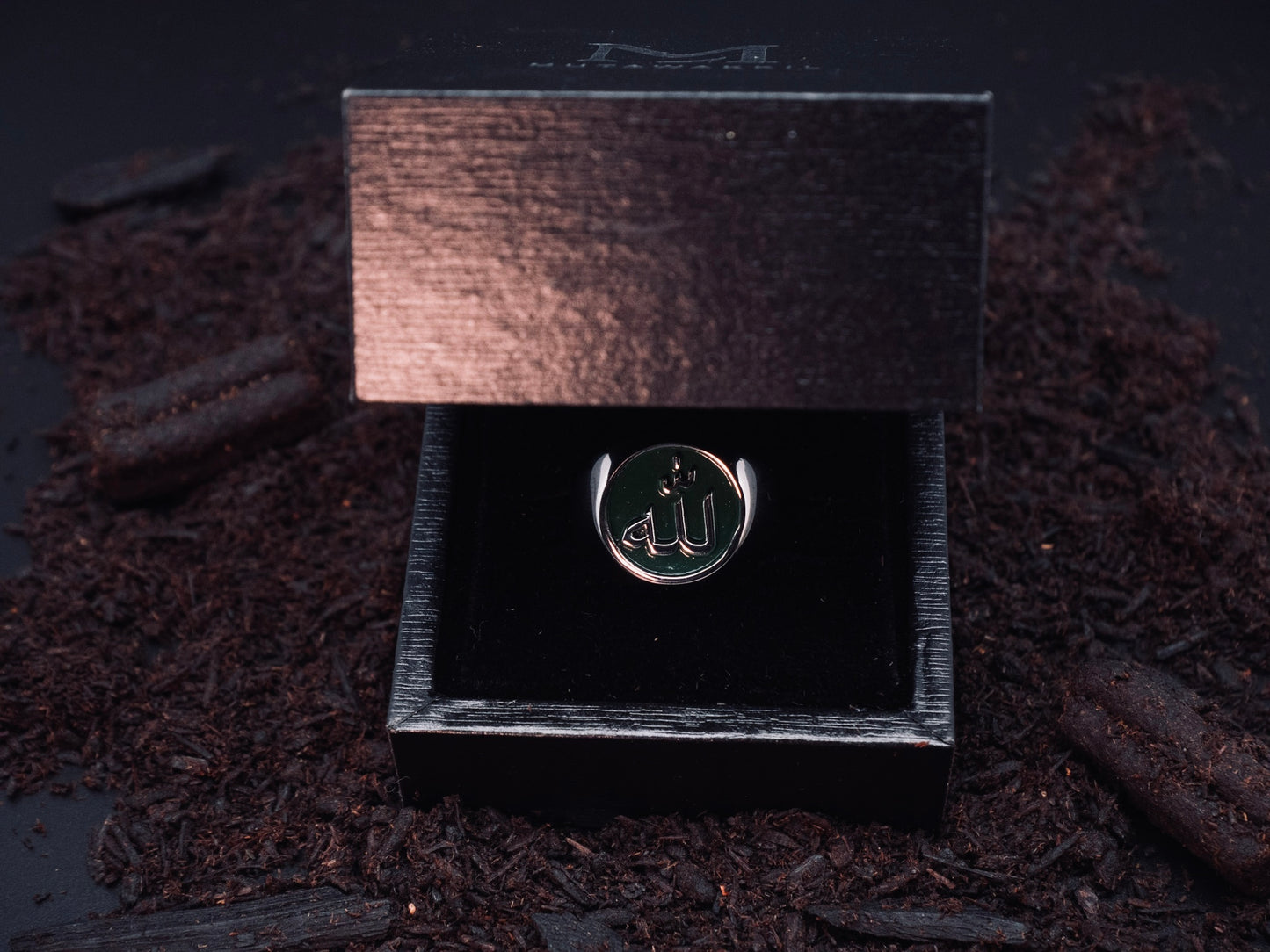 Mutawakkil Hikmah green Islamic ring engraved with Allah in Arabic calligraphy, presented in luxury black gift box.