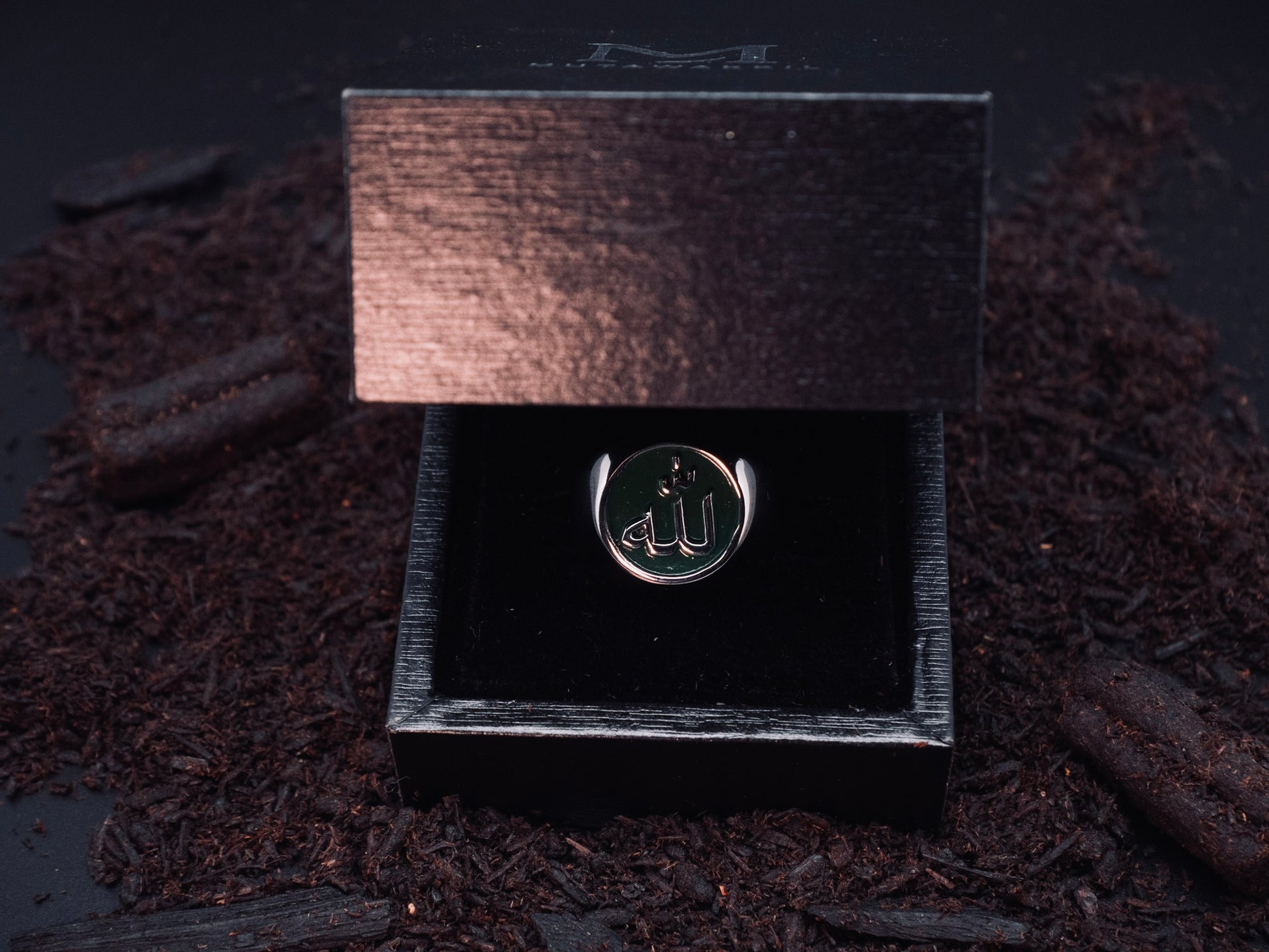 Mutawakkil Hikmah green Islamic ring engraved with Allah in Arabic calligraphy, presented in luxury black gift box.